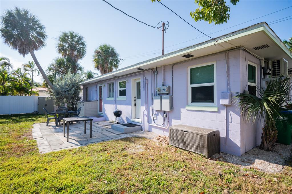 211 77th Street, Unit EAST Holmes Beach, FL 34217 - Photo 17 of 18 a backyard of a house with seating space