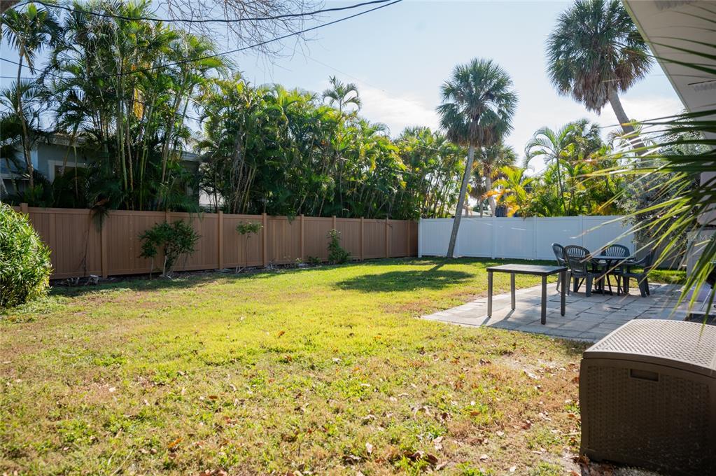 211 77th Street, Unit EAST Holmes Beach, FL 34217 - Photo 18 of 18 a swimming pool with outdoor seating and yard