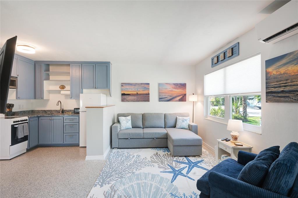 211 77th Street, Unit EAST Holmes Beach, FL 34217 - Photo 5 of 18 a living room with furniture and a large window