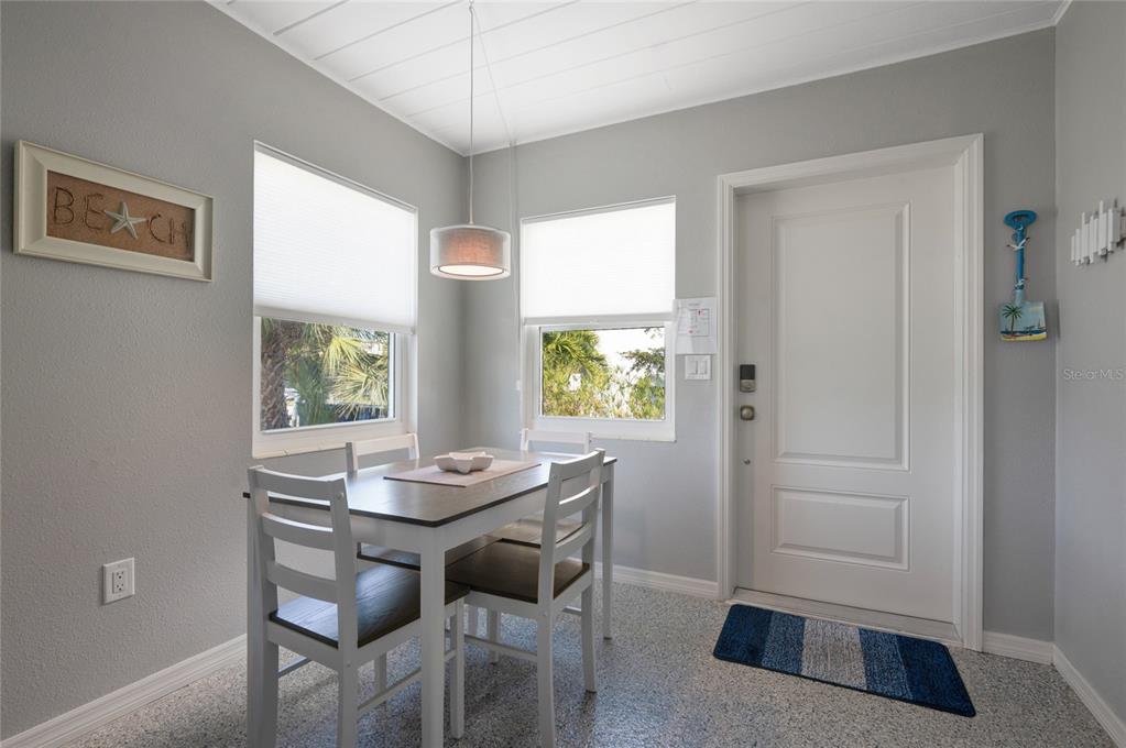 211 77th Street, Unit EAST Holmes Beach, FL 34217 - Photo 9 of 18 a view of a dining room with furniture and window