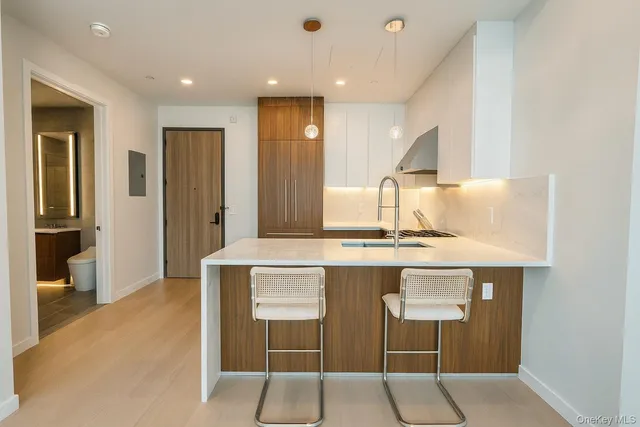 a kitchen with stainless steel appliances granite countertop a sink and a refrigerator