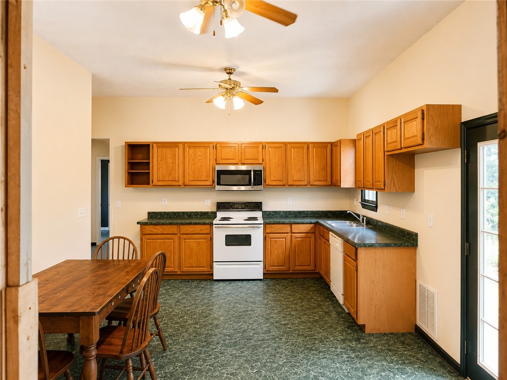 597 Old Hurricane Road Westminster, SC 29693 - Photo 7 of 11 Functional kitchen with ample cabinet space and a dedicated dining area.