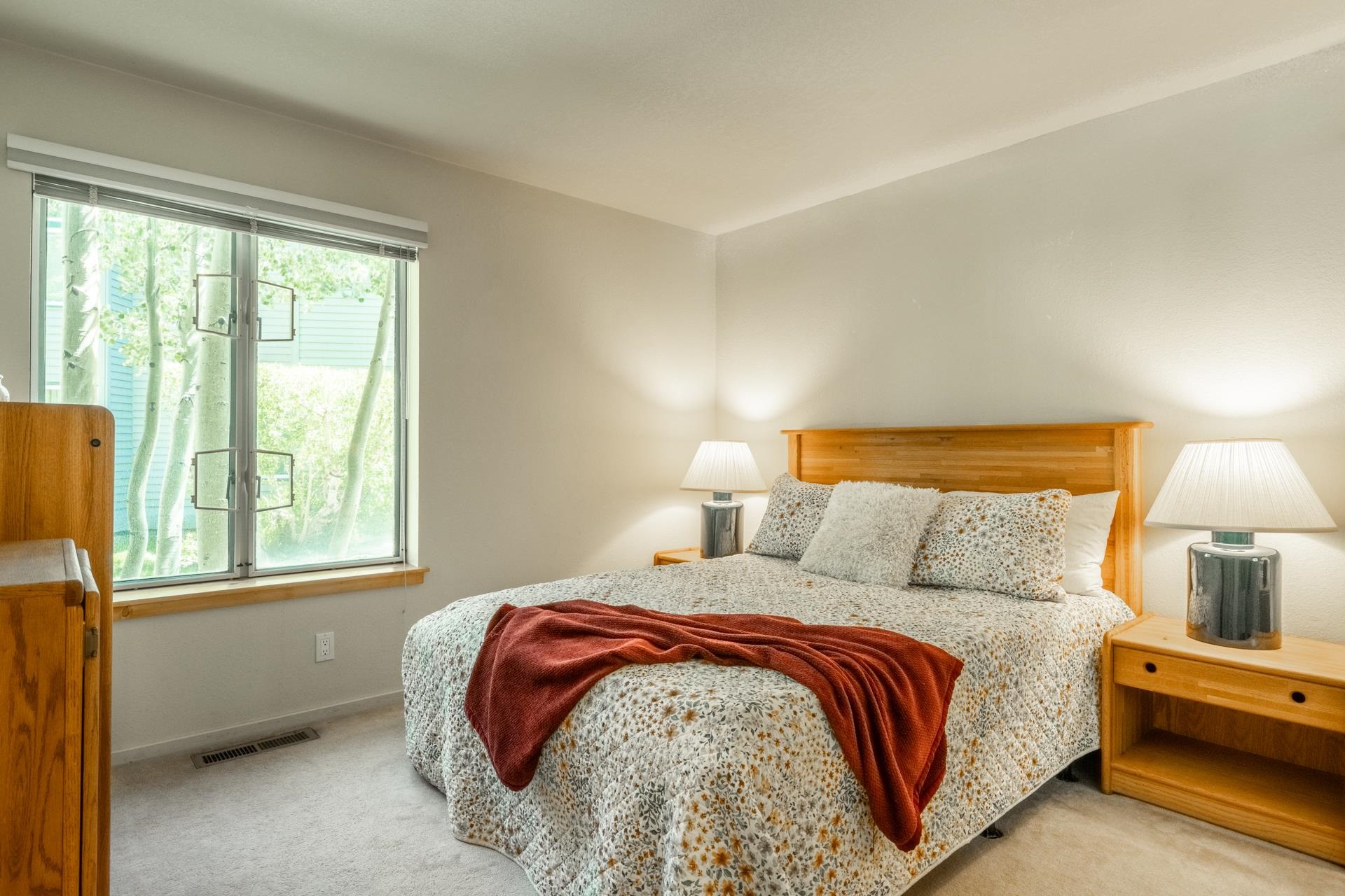 609 Golden Creek Road, Unit 609 Mammoth Lakes, CA 93546 - Photo 13 of 42 Carpeted bedroom featuring a large window with a wood-finish sill, light-toned walls, and a light-colored ceiling