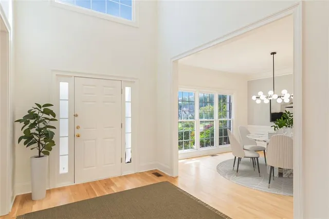 a view of a room with a window and wooden floor