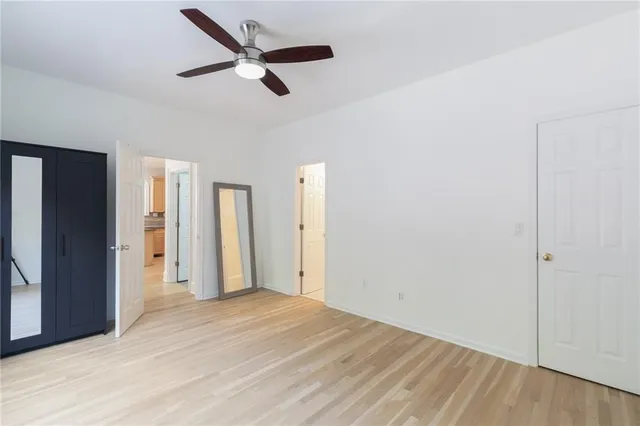a front view of house with yard and trees in the background