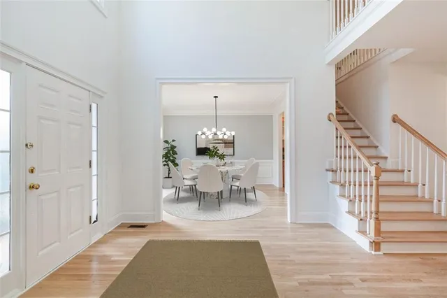 a view of a a dining room with furniture window and wooden floor
