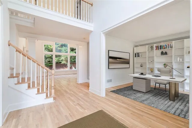 a dining room with furniture a chandelier and wooden floor