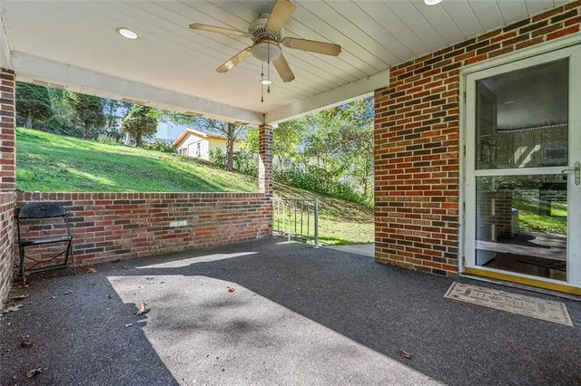 a view of a big house with a big yard and large trees