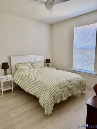 a bed sitting in a bedroom next to a window