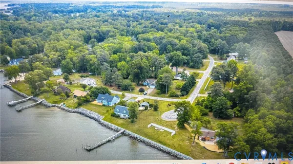an aerial view of a house with a yard basket ball court