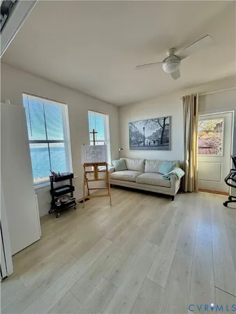 a living room with furniture and a wooden floor