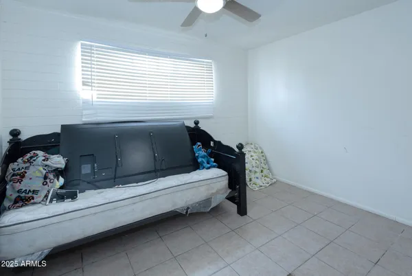 a bedroom with bed and window