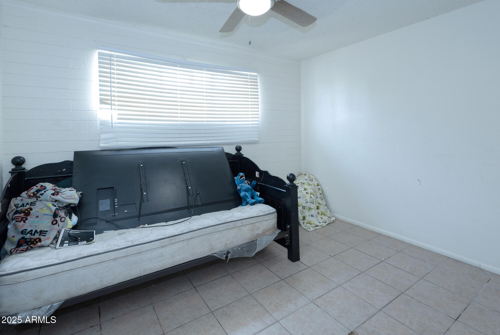 6826 South 8th Street Phoenix, AZ 85042 - Photo 13 of 22 a bedroom with bed and window