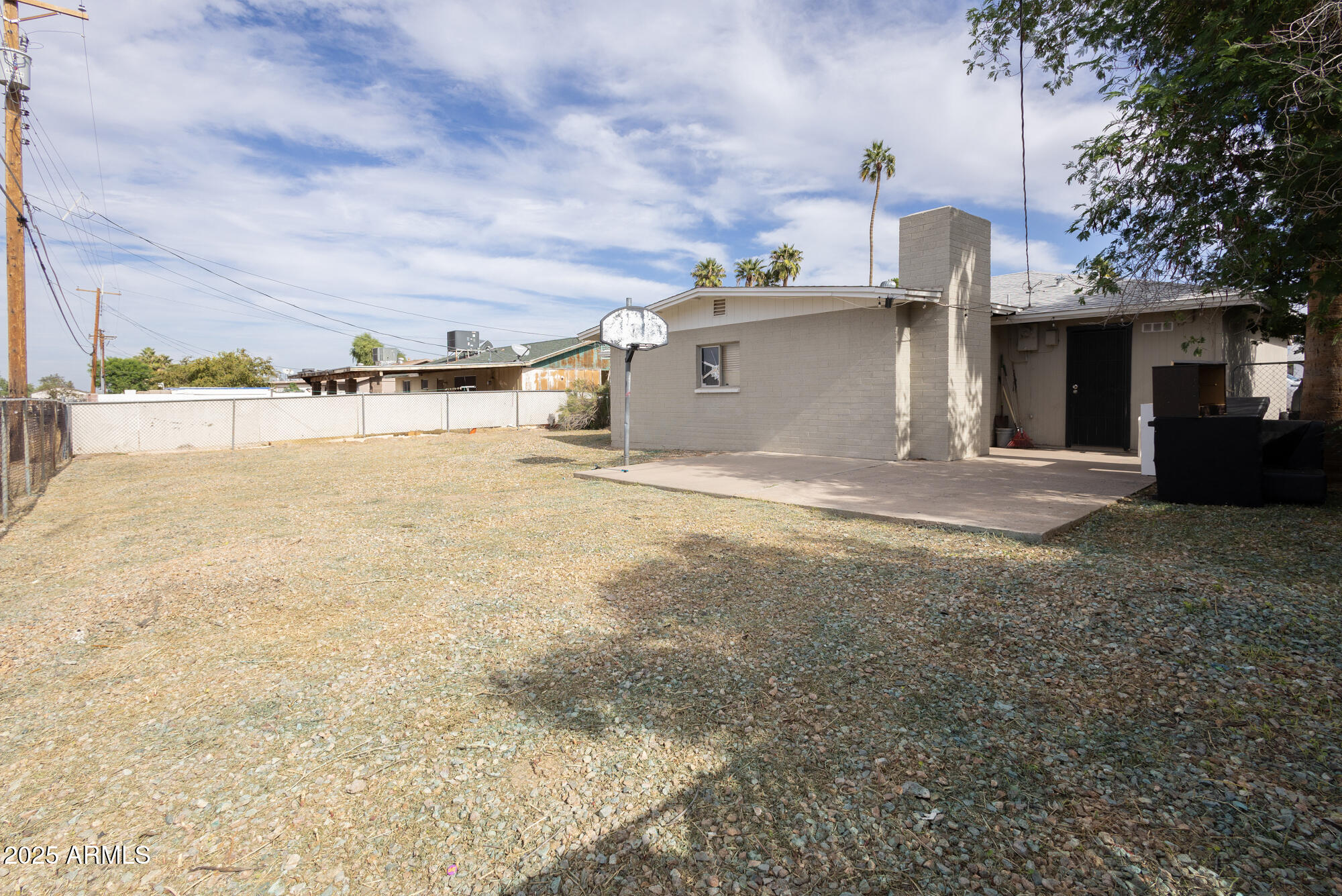 6826 South 8th Street Phoenix, AZ 85042 - Photo 16 of 22 a view of a house with backyard and a tree
