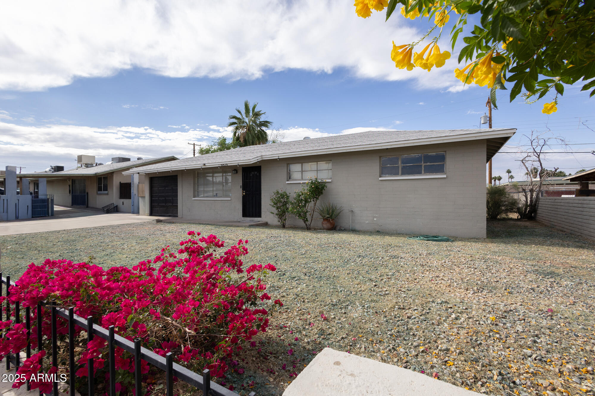 6826 South 8th Street Phoenix, AZ 85042 - Photo 19 of 22 a front view of a house with yard