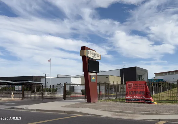 a street sign on a sidewalk next to a road