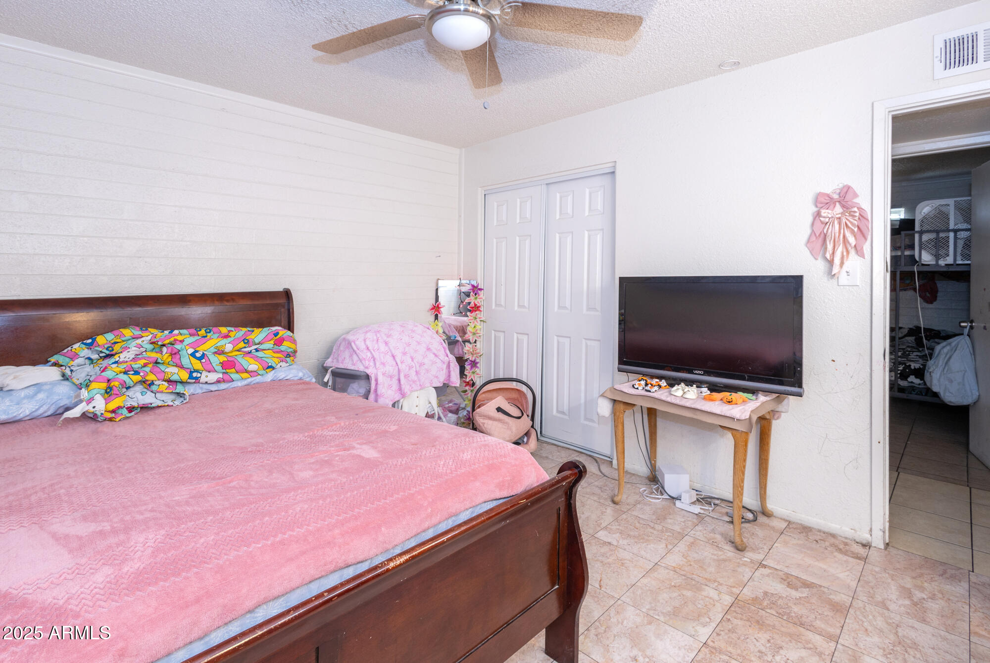 6826 South 8th Street Phoenix, AZ 85042 - Photo 9 of 22 a bedroom with a bed and a flat screen tv