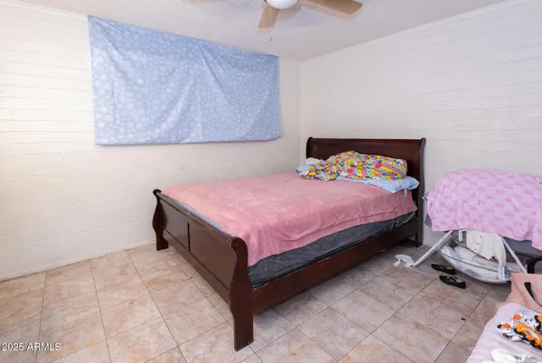 a bedroom with a bed and a chair