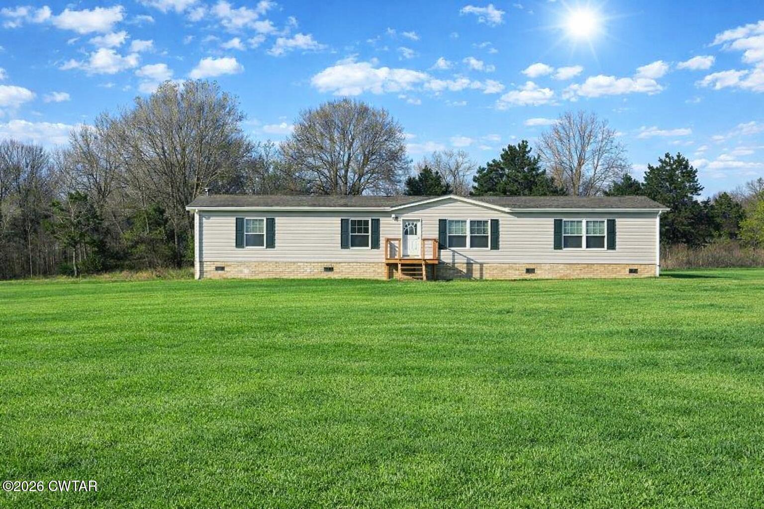 a front view of a house with a yard table and chairs