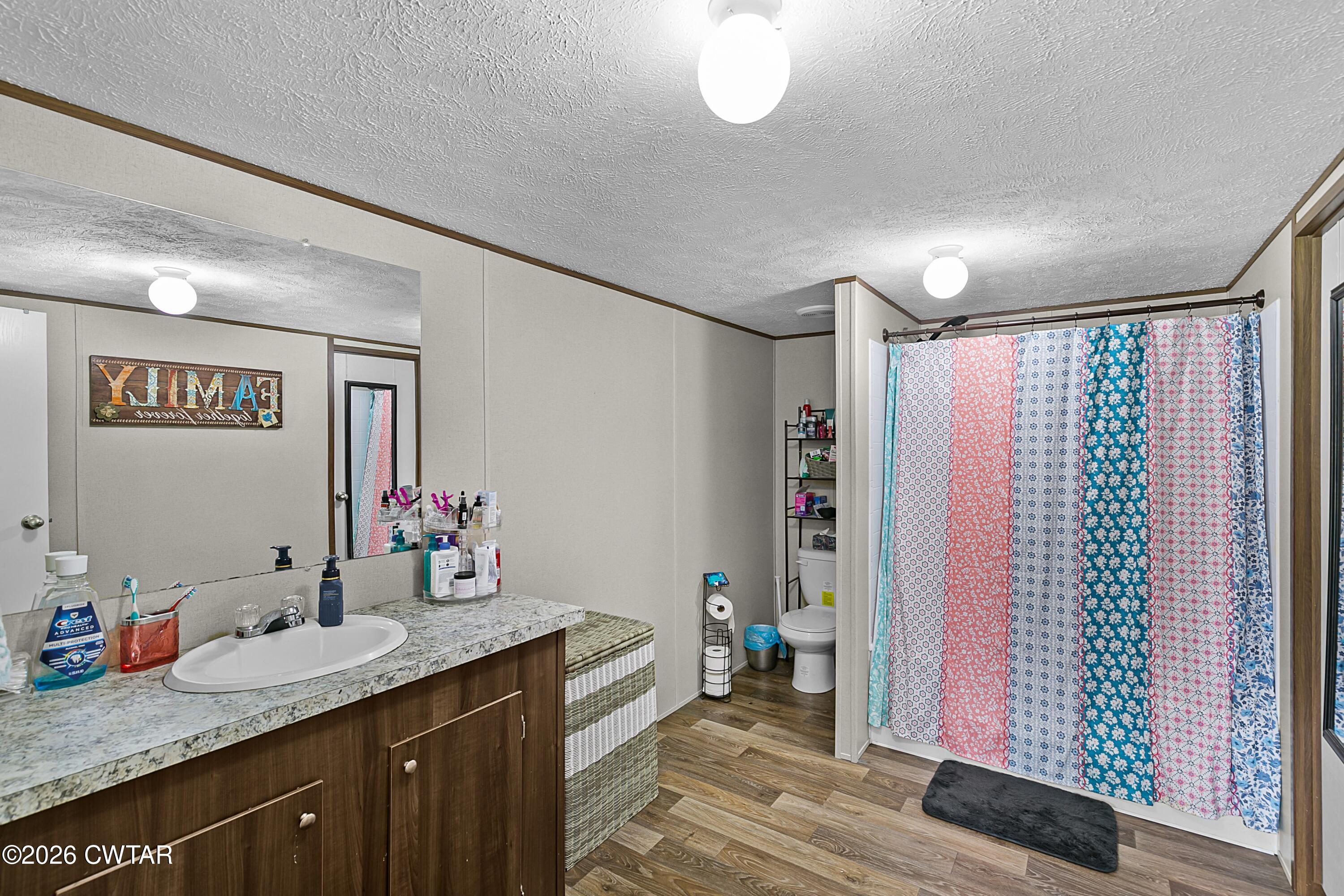 141 Persimmon Grove Road Trenton, TN 38382 - Photo 12 of 20 a bathroom with a granite countertop sink and a mirror