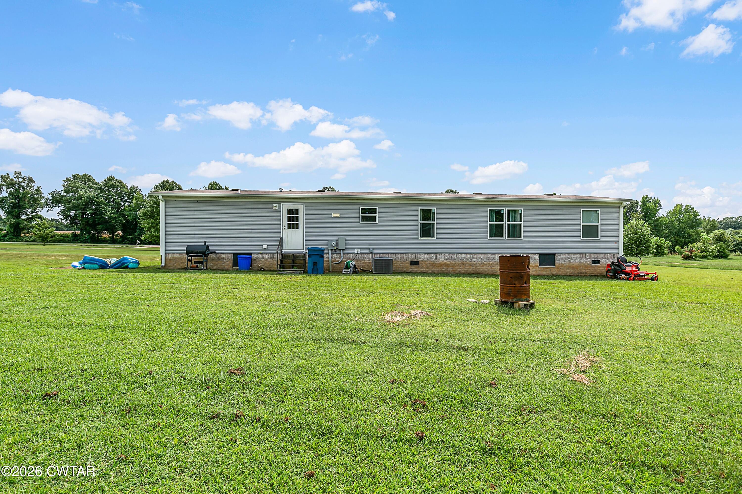 141 Persimmon Grove Road Trenton, TN 38382 - Photo 17 of 20 a front view of house with yard