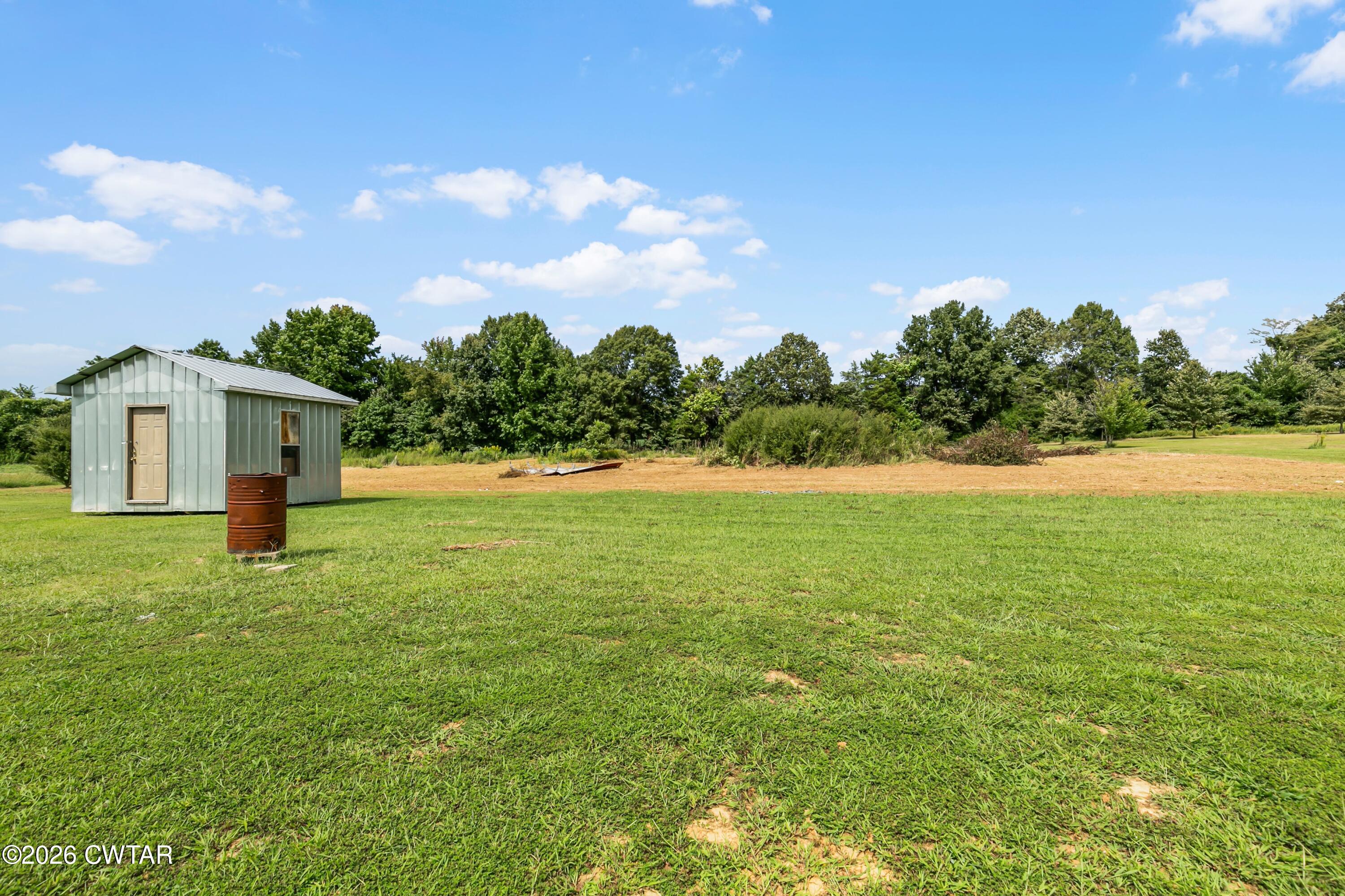 141 Persimmon Grove Road Trenton, TN 38382 - Photo 18 of 20 a front view of a house with garden