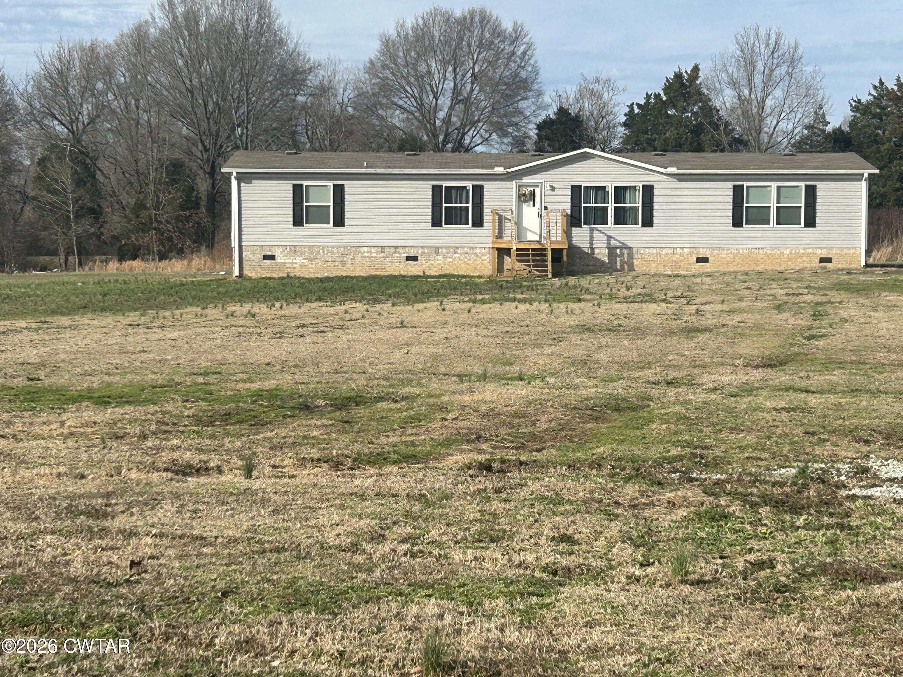 141 Persimmon Grove Road Trenton, TN 38382 - Photo 2 of 20 a view of a house with a yard