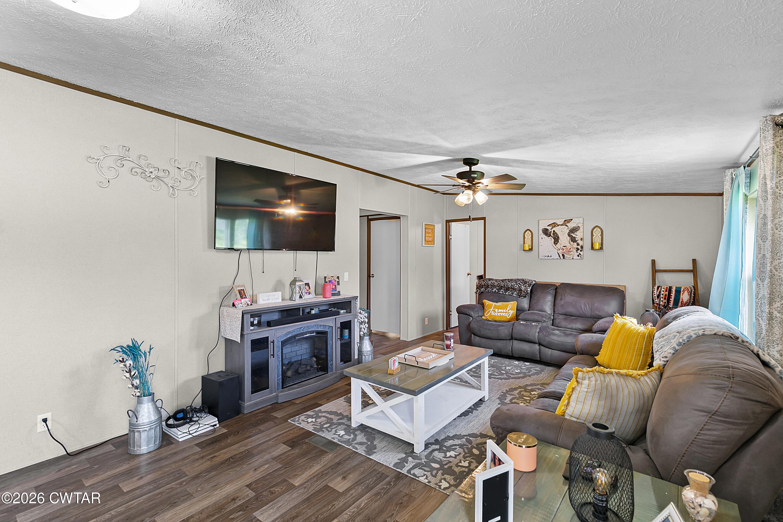 141 Persimmon Grove Road Trenton, TN 38382 - Photo 8 of 20 a living room with furniture and a flat screen tv