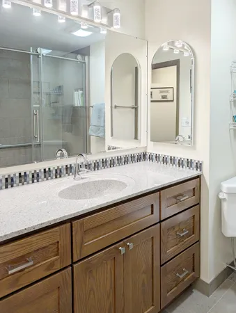 a bathroom with a granite countertop sink and a mirror