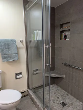a bathroom with a toilet and a shower