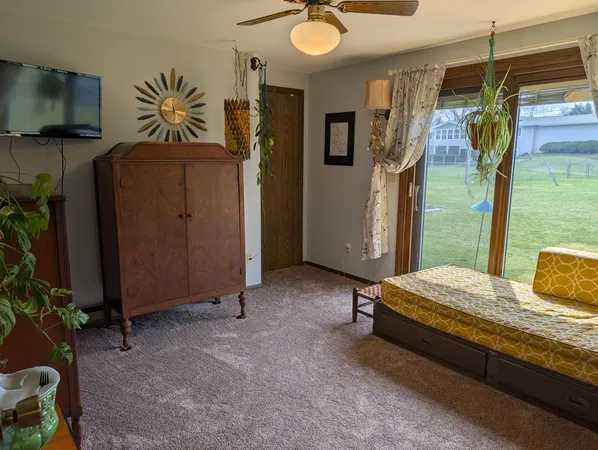 a bedroom with a bed and a flat tv screen