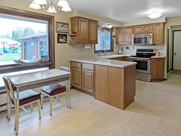 a kitchen with stainless steel appliances kitchen island granite countertop a sink and cabinets