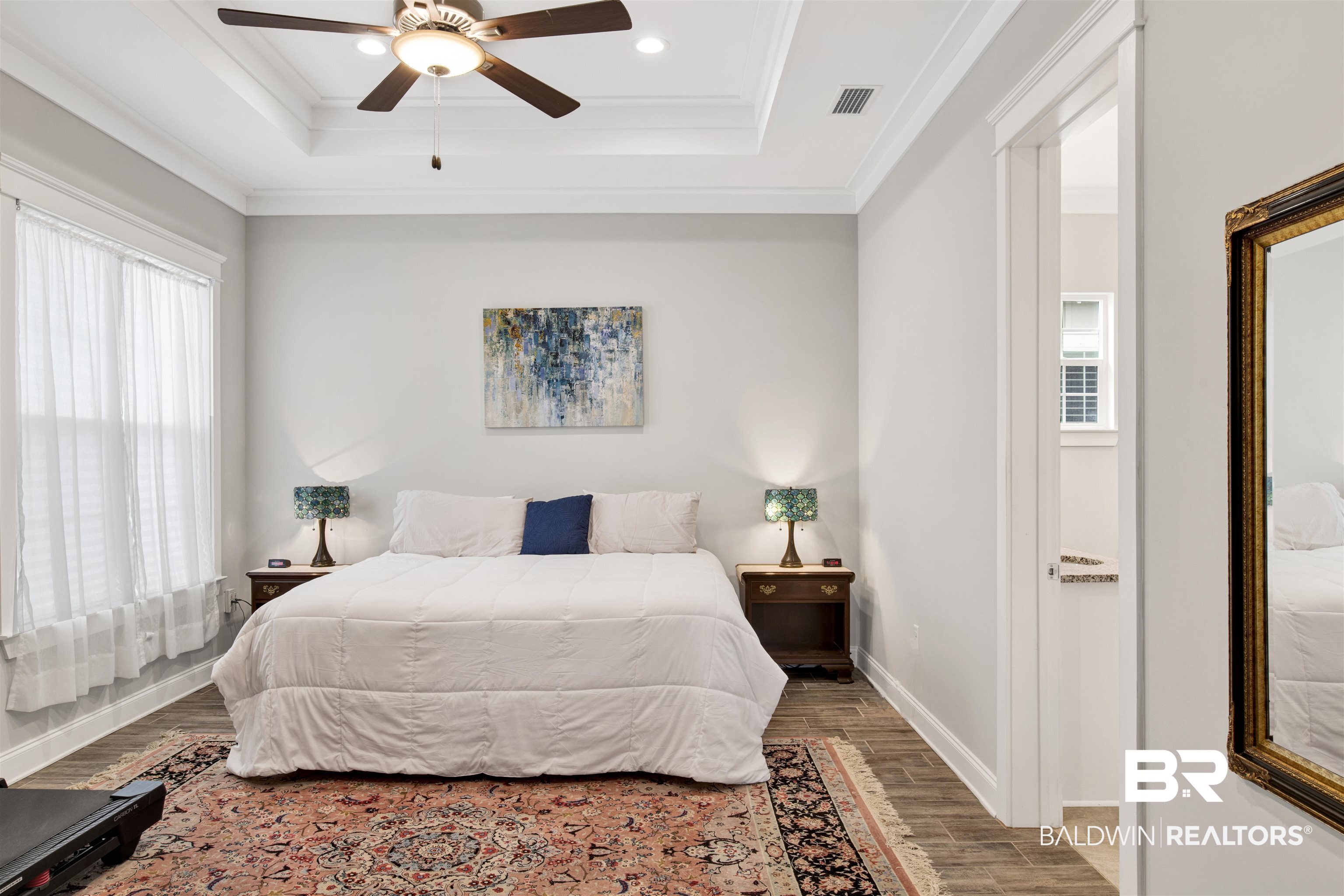 23893 Cypress Crossing Orange Beach, AL 36561 - Photo 12 of 22 Bedroom featuring wood finished floors, a tray ceiling, crown molding, a ceiling fan, and recessed lighting