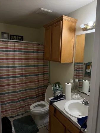 a bathroom with a sink toilet and mirror