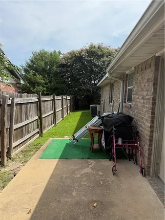a view of a backyard with a table and chairs