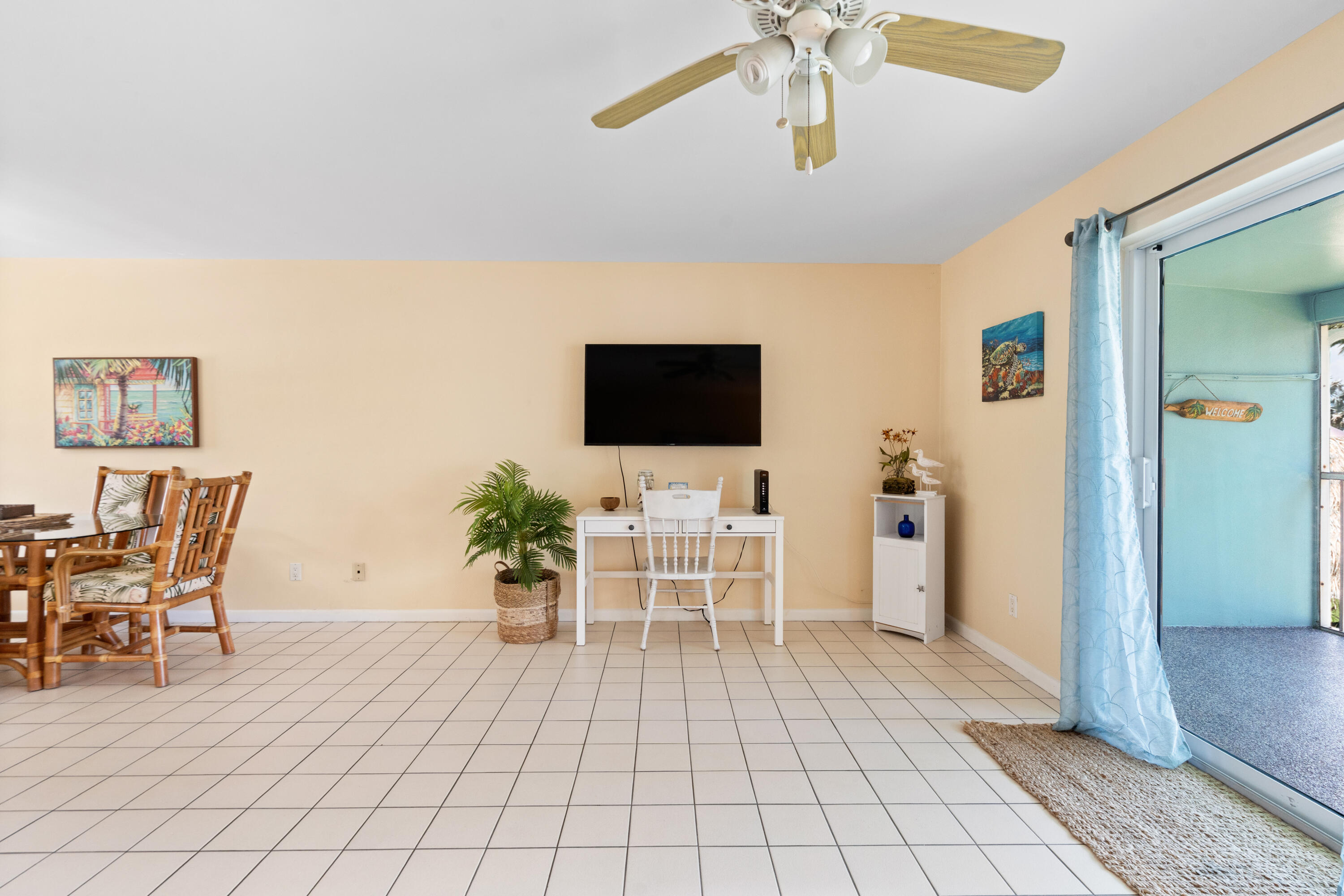 249 Center Street, Unit 2C Jupiter, FL 33458 - Photo 12 of 29 a living room with furniture and a flat screen tv