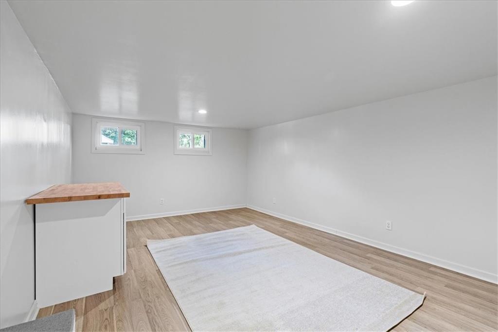 521 Benjamin Street Tarentum, PA 15084 - Photo 14 of 19 an empty room with wooden floor and windows