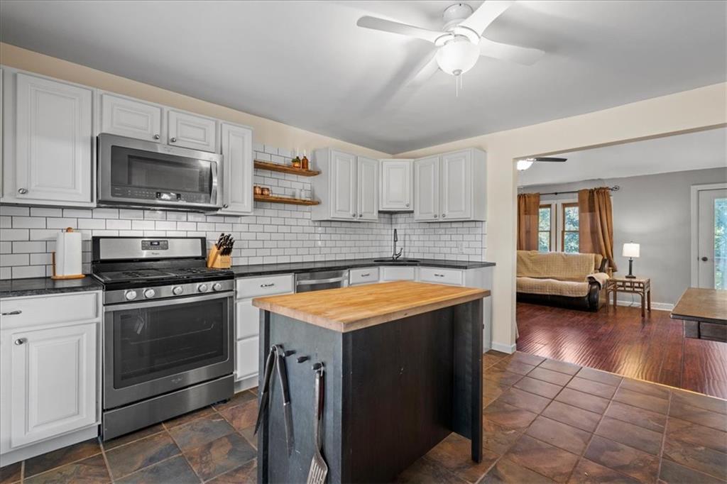 521 Benjamin Street Tarentum, PA 15084 - Photo 2 of 19 a kitchen with stainless steel appliances granite countertop a stove sink microwave and cabinets