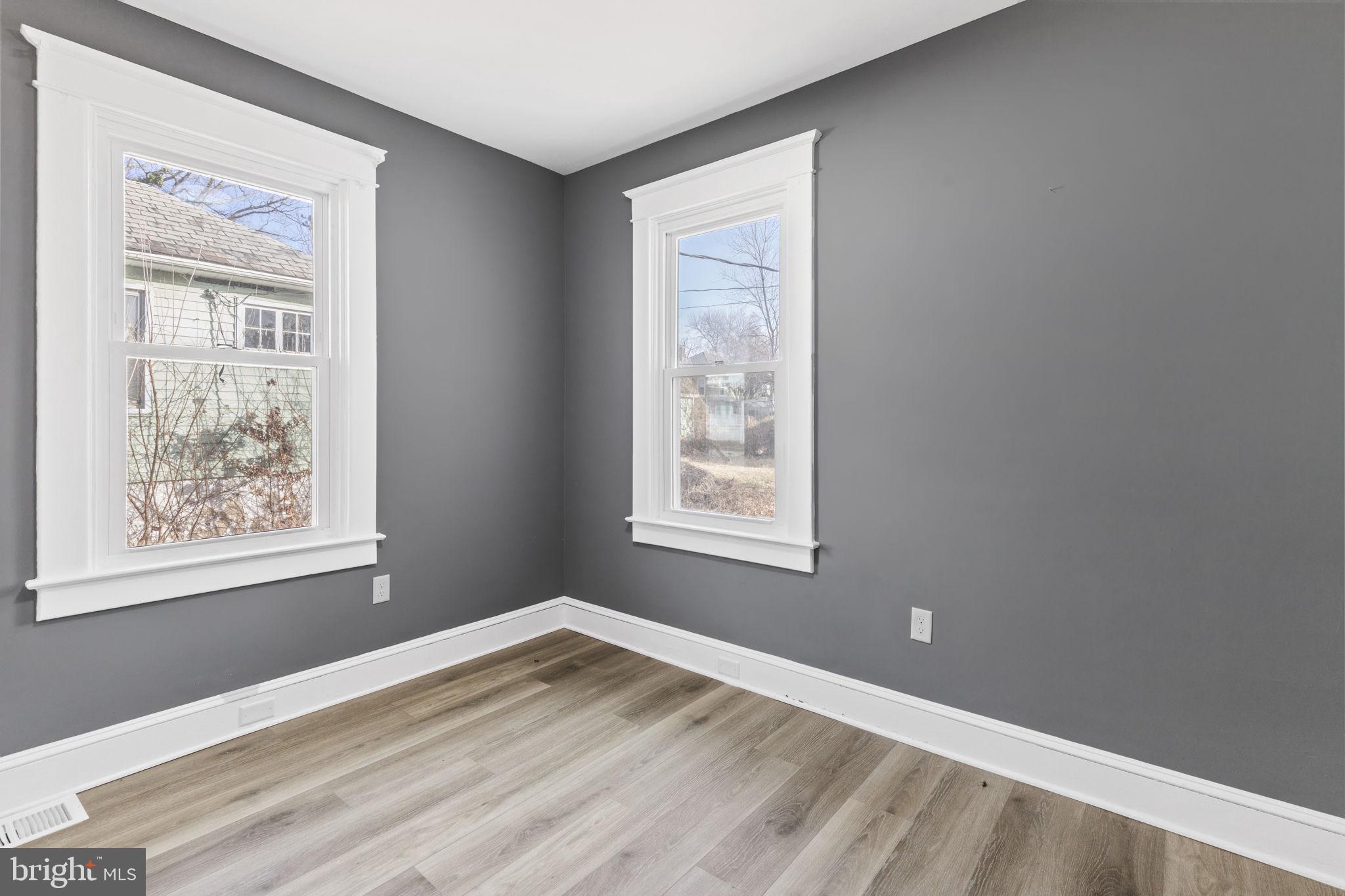 5613 Plymouth Road Baltimore, MD 21214 - Photo 11 of 31 a view of an empty room with wooden floor and a window