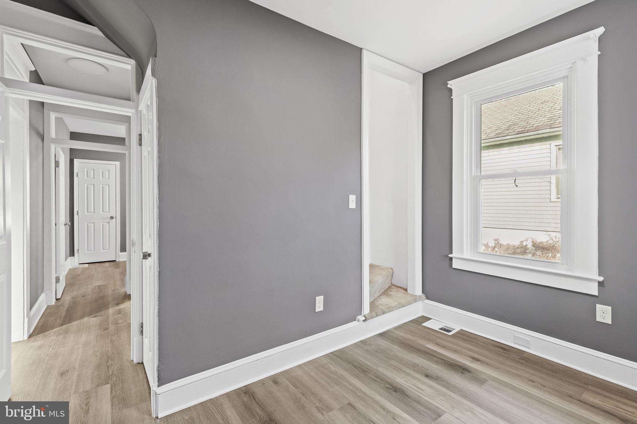 5613 Plymouth Road Baltimore, MD 21214 - Photo 12 of 31 a view of an empty room with wooden floor and a window
