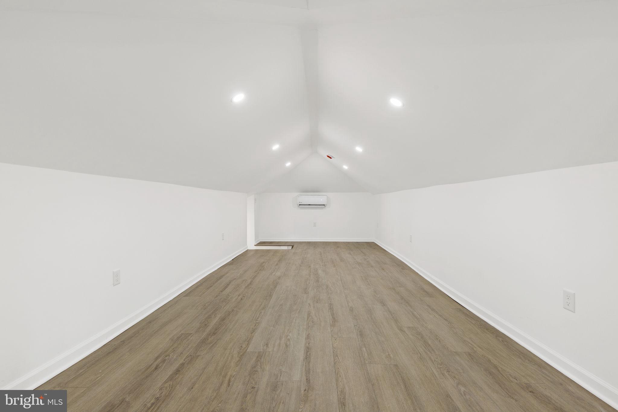 5613 Plymouth Road Baltimore, MD 21214 - Photo 14 of 31 an empty room with wooden floor and windows