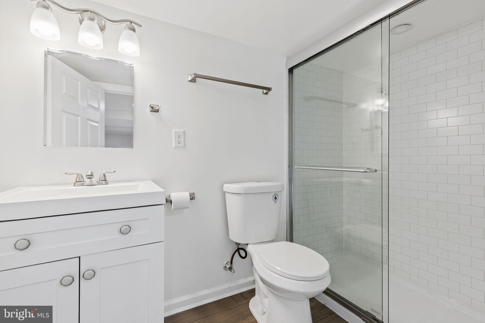 5613 Plymouth Road Baltimore, MD 21214 - Photo 17 of 31 a bathroom with a sink toilet and vanity