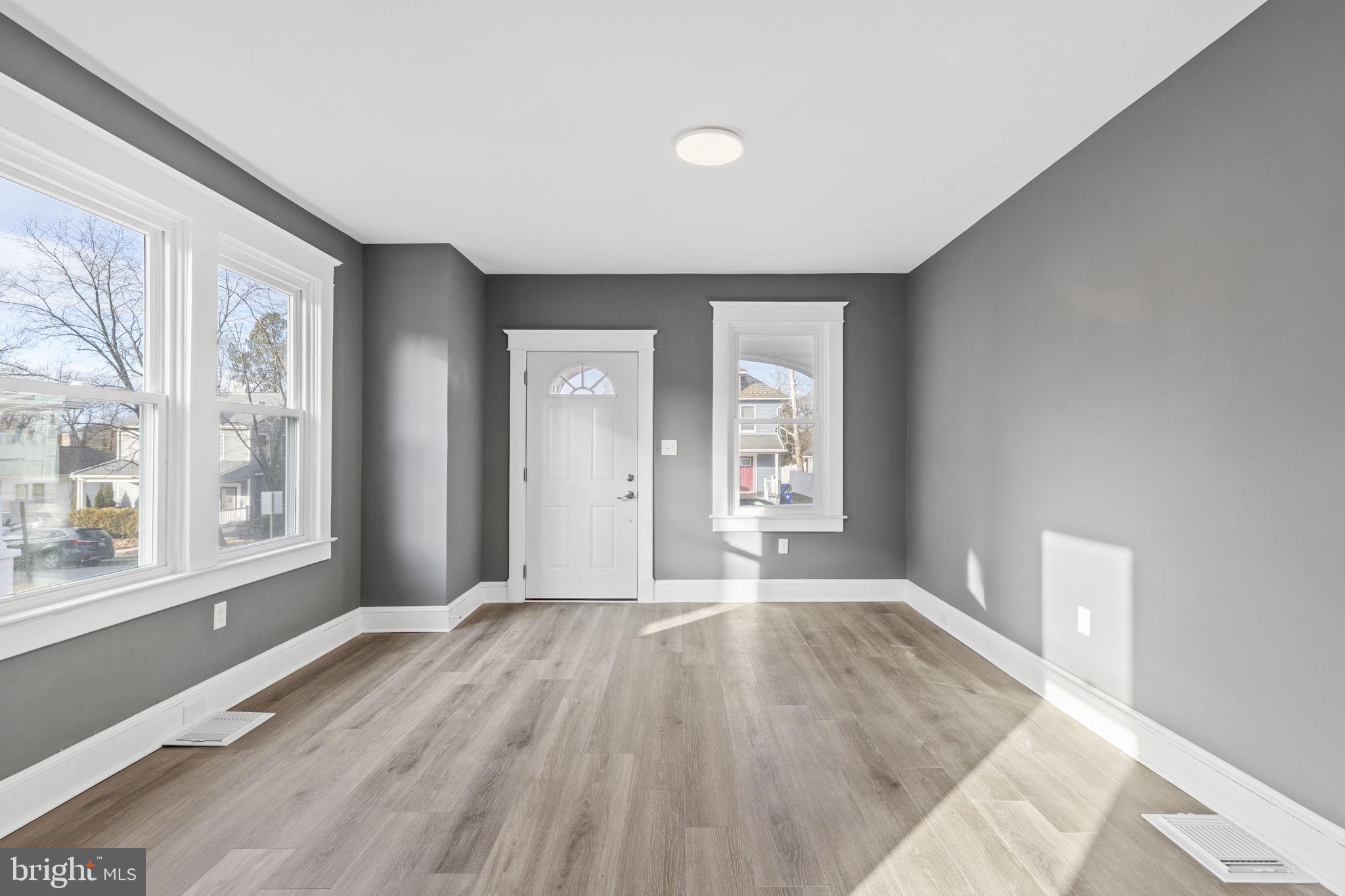 5613 Plymouth Road Baltimore, MD 21214 - Photo 2 of 31 wooden floor in an empty room with a window