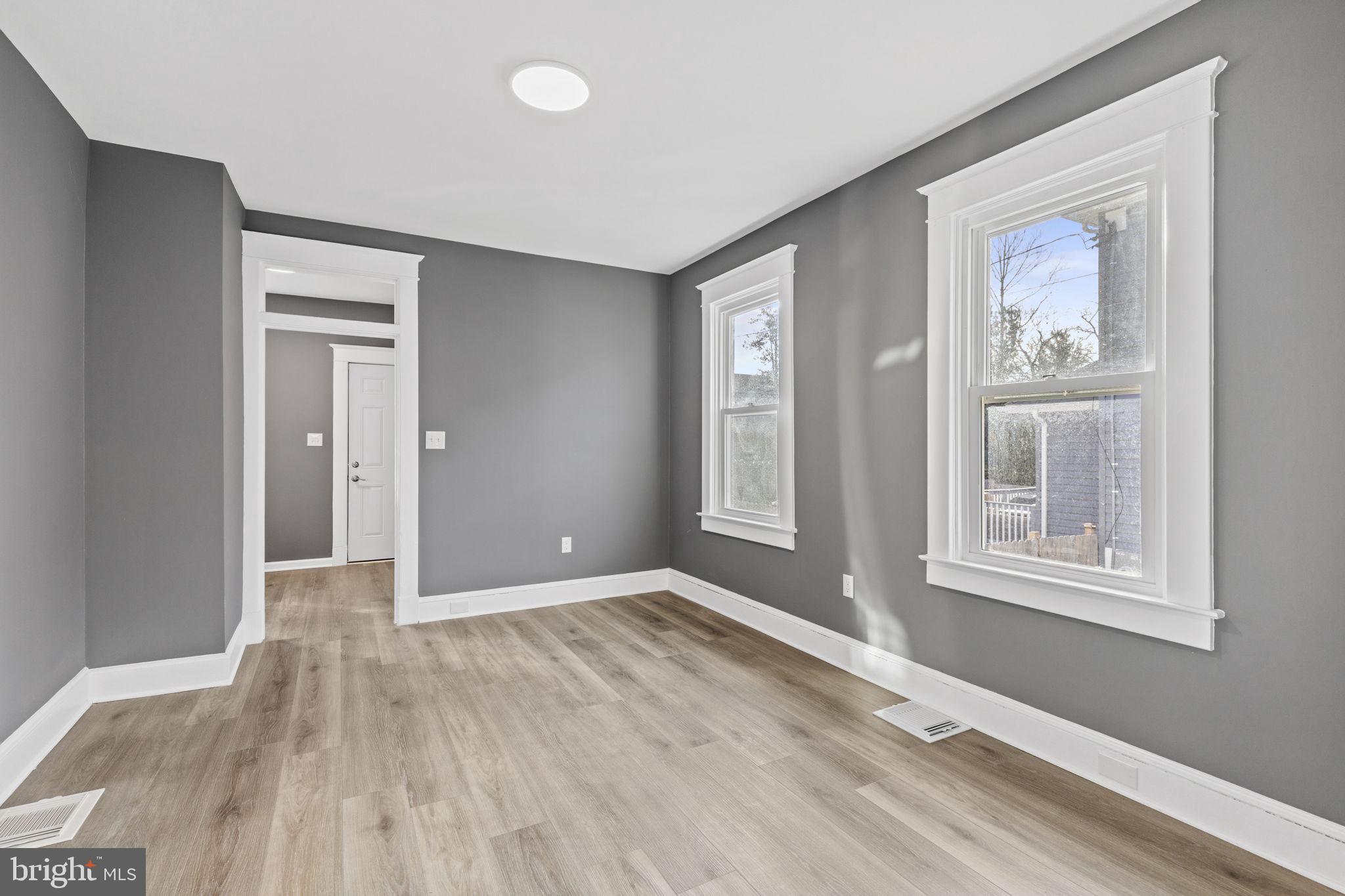 5613 Plymouth Road Baltimore, MD 21214 - Photo 4 of 31 a view of an empty room with wooden floor and a window