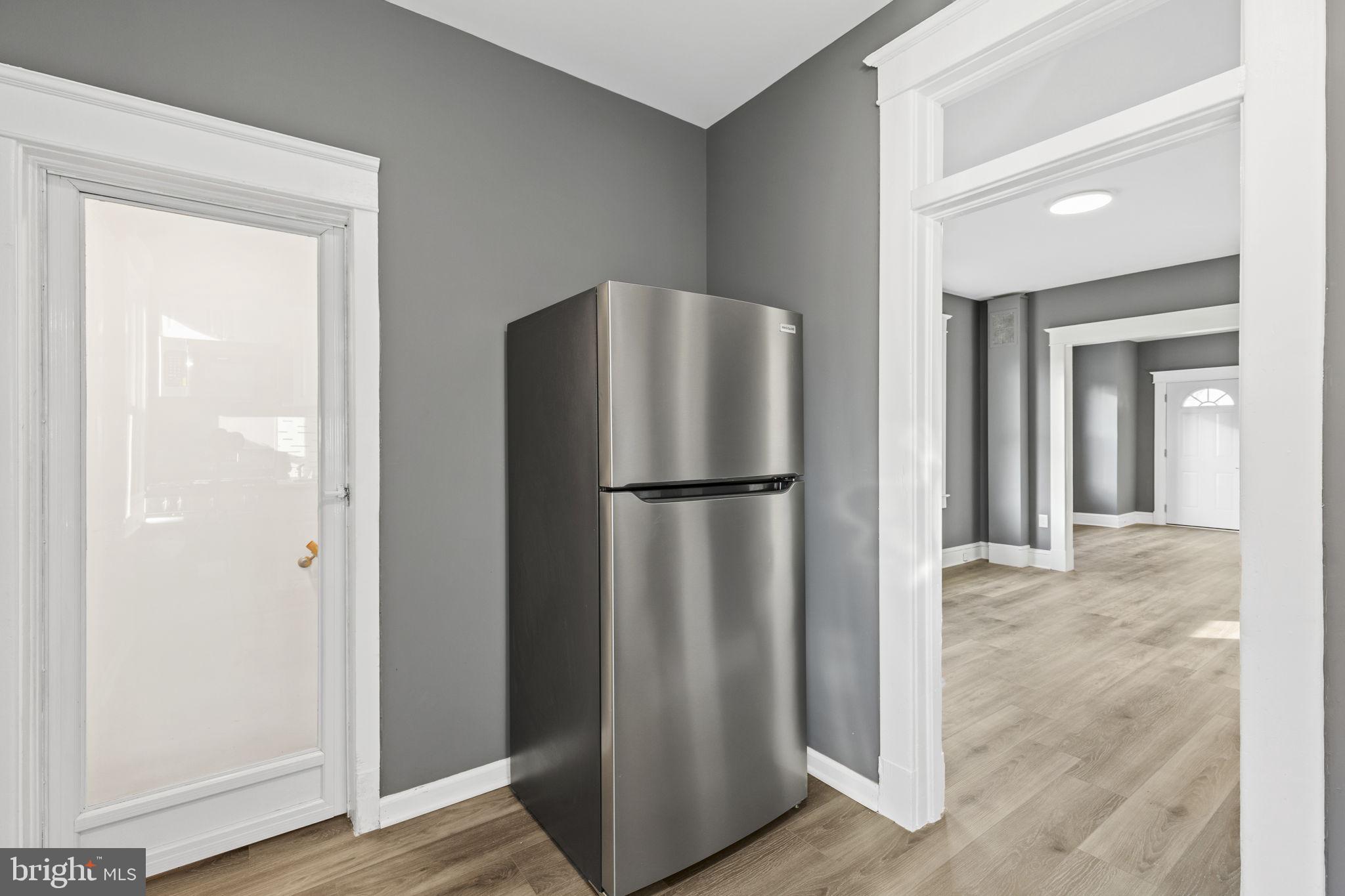 5613 Plymouth Road Baltimore, MD 21214 - Photo 7 of 31 a view of a kitchen with refrigerator and wooden floor