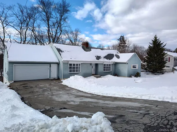 a view of a house with a snow on the road