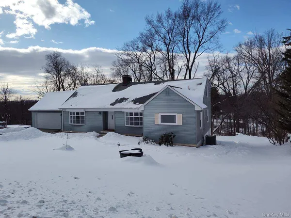 a wooden bench sitting in the middle of a yard