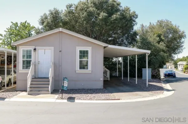 a view of a kitchen and an entryway with wooden floor