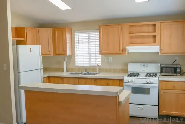 a room with wooden floor and a fireplace