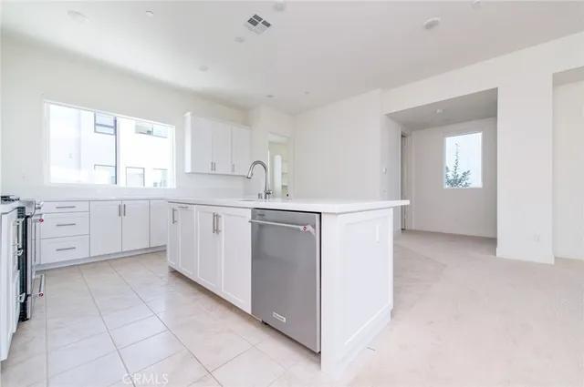 a view of a kitchen with white cabinets